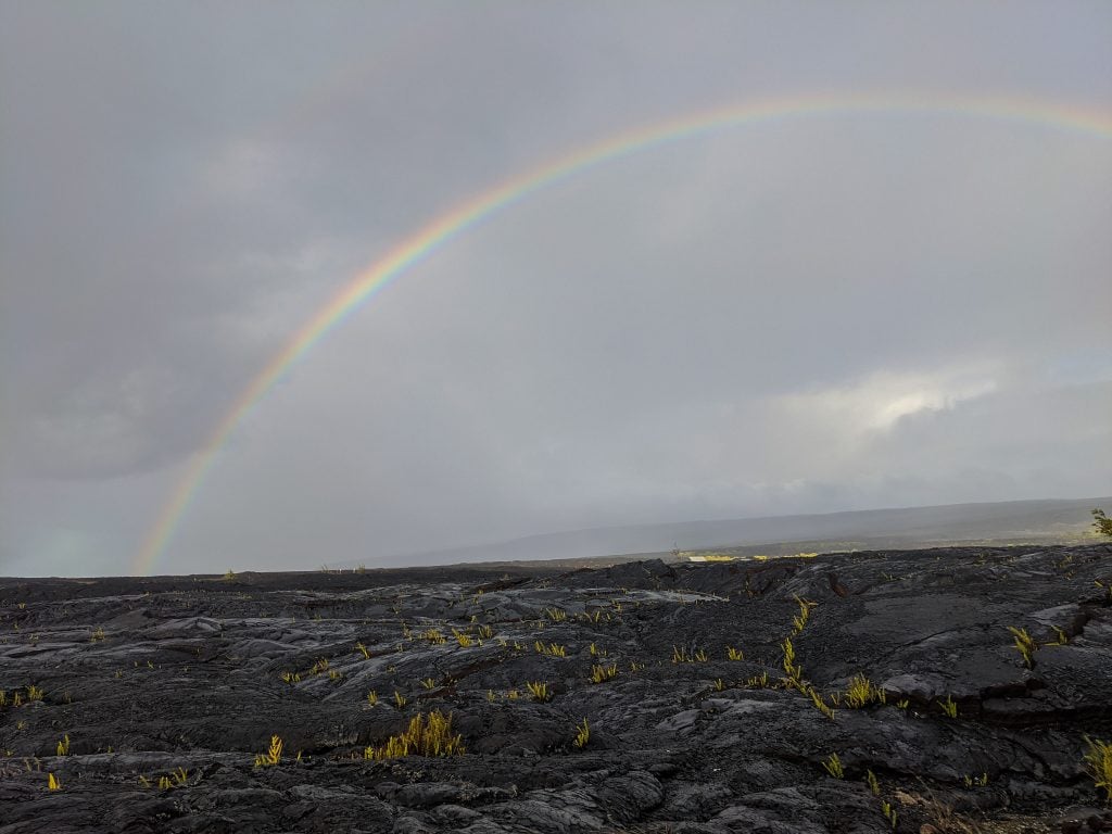 Lava Field With Rainbow After A Heavy Rainstorm.